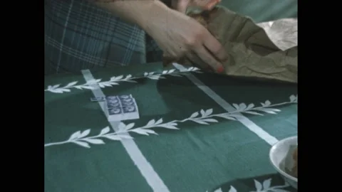 1950s: Woman places stack of mail into paper bag. Watch on woman's wrist. Girl Stock Footage 172031734