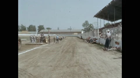 1950s: Workers prep the track for the tractor pull.  Tractors smoothing out dirt Stock Footage 165356410