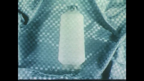 1950s: Yard spool superimposed over fabric / Hands with bathing suit / Pan of Stock Footage