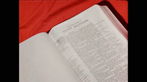 1950s:Bible open to Matthew. Religious scripture text superimposed over Stock Footage 232948170