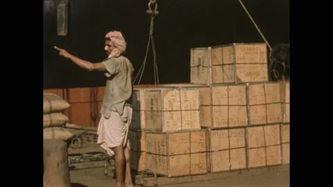 1950s:Men stack boxes in piles. Light shone into man's eyeball repeatedly, 스톡 동영상 233207265