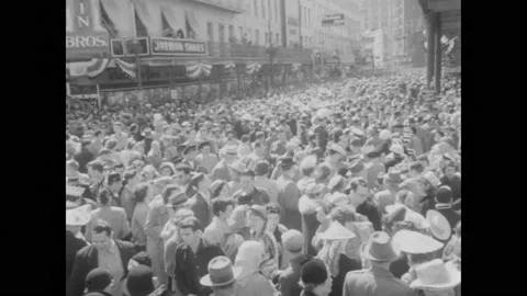 1950s:Parade float in middle of crowd. People dance in crowd. People in costumes Stock Footage 217749078