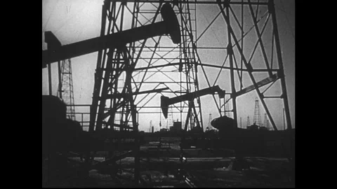 1950s:Various shots of oil wells pumping Stock Footage