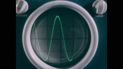 1950s:White pen points to sine waves on oscilloscope. Intensity and focus knobs 動画素材 220809446