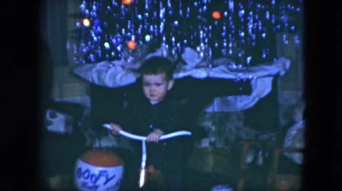 1951: an infant is in front of the tree and waving, blowing kisses. CLEVELAND, Stock Footage