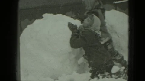 1951: kids are making huge snowman GERMANY Stock Footage
