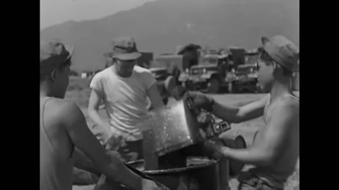 1951 - Locals help US Army engineers finish making napalm mixtures in Korea. Stock Footage 173401828