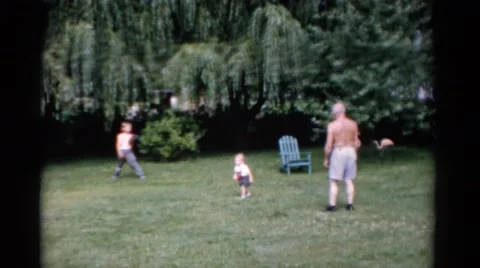 1951: a man and two small boys in backyard with baseball and gloves having fun. Stock Footage