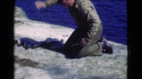 1951: a man on the seashore displays a group of freshly caught fishes CANADA Stock Footage