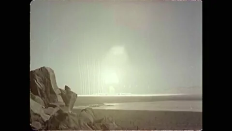 1951 - A mushroom cloud bursts at an atomic bomb testing site in the desert. Stock Footage 152507727