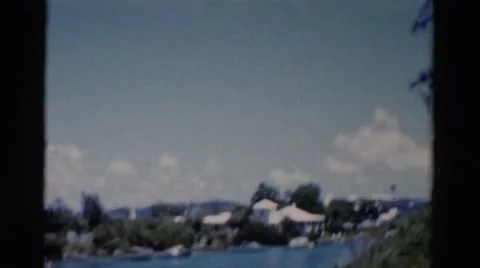 1951: shaky spy video of tropical area mansion homes across water FLORIDA Stock Footage