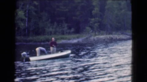 1951: a shirt shirt man is is fishing from a river CANADA Stock Footage