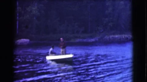1951: two men going out on the lake in a boat ready to catch some big fish Stock Footage