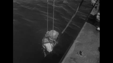 1951 - A US Navy diver is lowered into the water and brought back up. 스톡 동영상 106902570