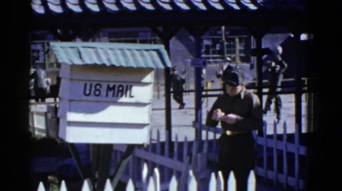1952: Officer in Uniform Scribbles Notes While Others Play Volleyball Stock Footage 67971585