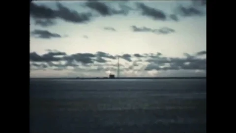 1952 - A thermonuclear device is detonated and crewmen watch the mushroom cloud Stock Footage 85648641