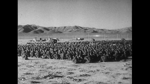 1952 : US Army soldiers watch as an atomic bomb is detonated. Stock Footage