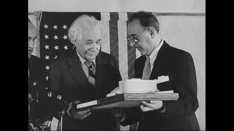 1953 - Albert Einstein is presented with a scale model of the medical school 스톡 동영상 125695299