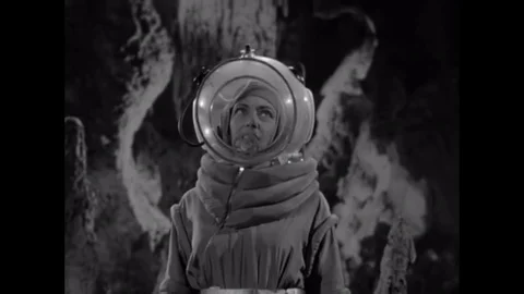 1953 - A crew of astronauts, which includes a woman, explores a cavern on the Stock Footage 129450535
