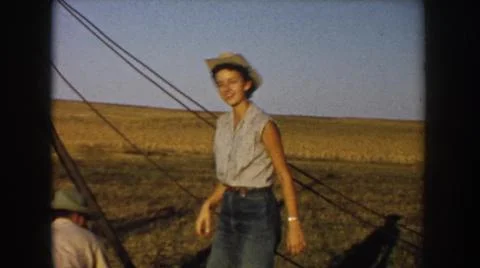 1953:SOUTH DAKOTA USA. Country Girl Working In Field With Cowgirl Boots Getting Stock Photos