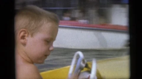 1954: adults watching children go around in boats PENNINGTON, NEW JERSEY Stock Footage