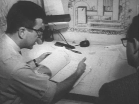 1954 - An architect meets with a client and a scale model is made at Eberle M. Stock Footage 83610968