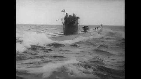 1954 - A German U-boat cuts through the waves. An officer on the platform makes Stock Footage 228942667