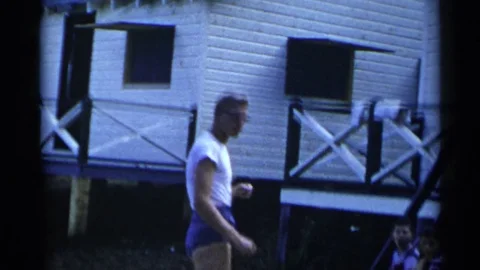 1954: Two Boys Being Coached by Scantily Clad Man to Throw Baseball New York Stock Footage 73159215