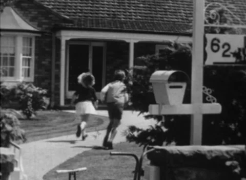 1955: Australian Postman (Postie) Delivers Letters to Children Stock-Footage 153457239