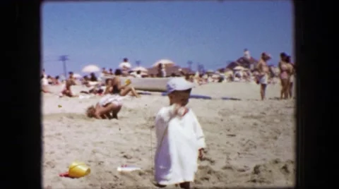 1955: Beach Toddler Boy Sunscreen Protection White Sand Digging Play Summer Video stock 64576892