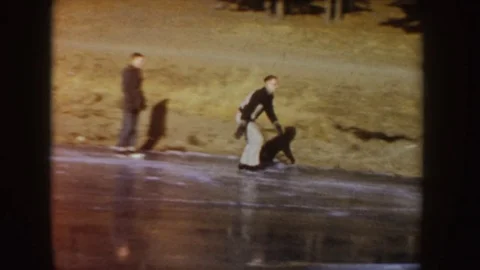 1955: Man Ice Skating and Performing Tricks on a Frozen Lake with Friends IDAHO Stock Footage 69927765
