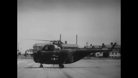 1955 - A military pilot lifts off in a helicopter, reduces the collective pitch, Stock Footage