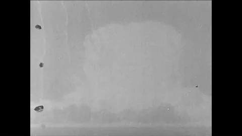 1955 - A nuclear device explodes into a mushroom cloud a house is destroyed and Stock Footage 85947932
