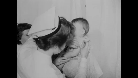 1955 - Nurses and doctors administer polio vaccine shots to young children. Stock Footage 132195804
