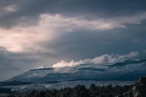 A beautiful landscape view of trees under snow cliffs against a gray sky in Matroosberg, South Africa xkwx abstract, background, beautiful, beauty, blue, cloud, clouds, geology, hill, landscape, Matroosberg, natural, nature, outdoor, outdoors, rock, scenic, sky, snow, South Africa, stone, sunny, texture, travel, tree, trees, view, water, white, winter