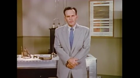 1956 - A man in a scientific lab reads the scriptures of the Bible about Mary 스톡 동영상 246359448