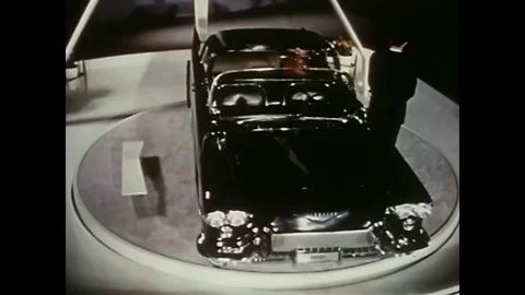 1956 - A model in designer clothes poses with new cars at a GM Motorama car Stock Footage 88958442