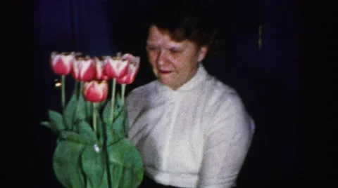 1956: a mother is seen with flowers MADISON, WISCONSIN Stock Footage