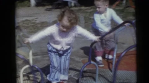 1956: two kids enjoying a revolving ride in a park FLORIDA Stock Footage