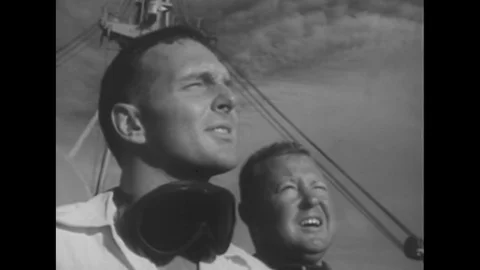 1956 - Two men watching, and the beginning of a nuclear explosion in the Pacific Stock Footage 115452369