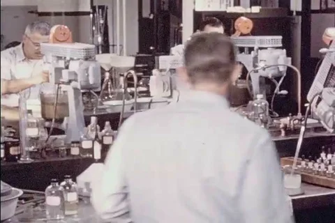 1957 - A chemist uses a flotation machine to analyze a sample of copper ore. Stock Footage 99404486