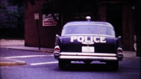 1957 Chevrolet police car patrols city streets 1950s vintage home movie 4365 Stock Footage