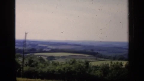 1957: Countryside is patchwork of land in green, gray and blue under the sky Video stock 73820062
