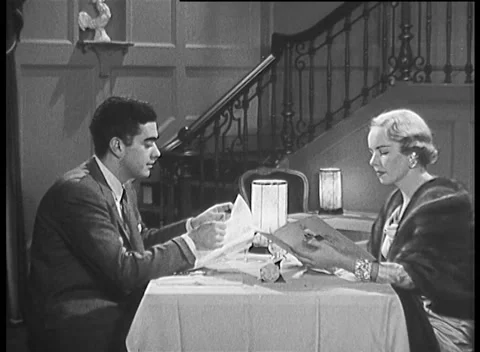 1957, COUPLE ORDERING DINNER AT RESTAURANT Stock Footage 158738515