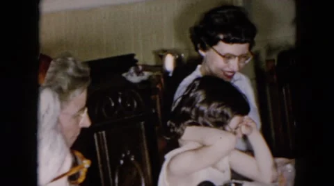 1957: five members of family sitting around the table enjoying meal together Stock Footage