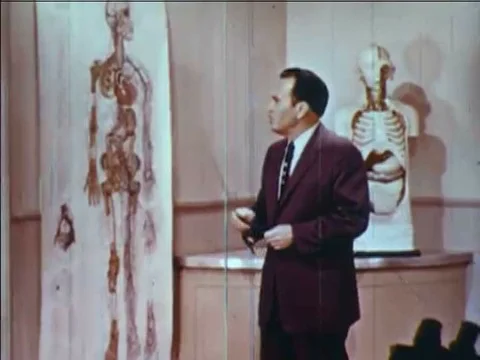 1957  A man explains how oxygen interacts with the bloodstream through the Stock Footage 83214377