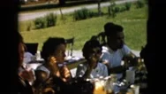 1957: People Feasting On A Table Talking Having A Picnic Good Time Together Stock Footage
