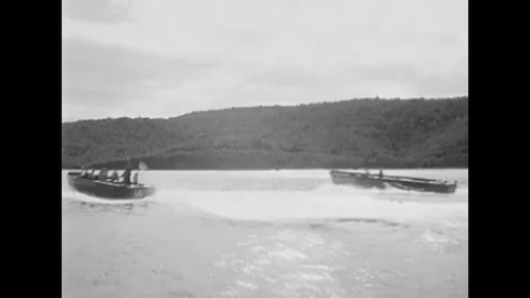 1957 - Two high speed US Navy boats are seen underway, collecting divers. Stock Footage 120937247