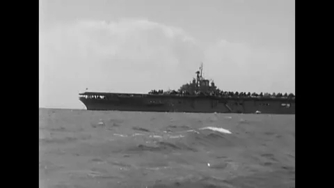1957 - US Navy divers are seen diving off a boat near the USS Boxer. Stock Footage 120937012