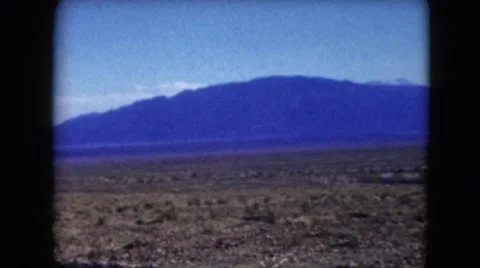 1957: vast barren land fringed by blue mountains in the distant DEATH VALLEY Stock Footage
